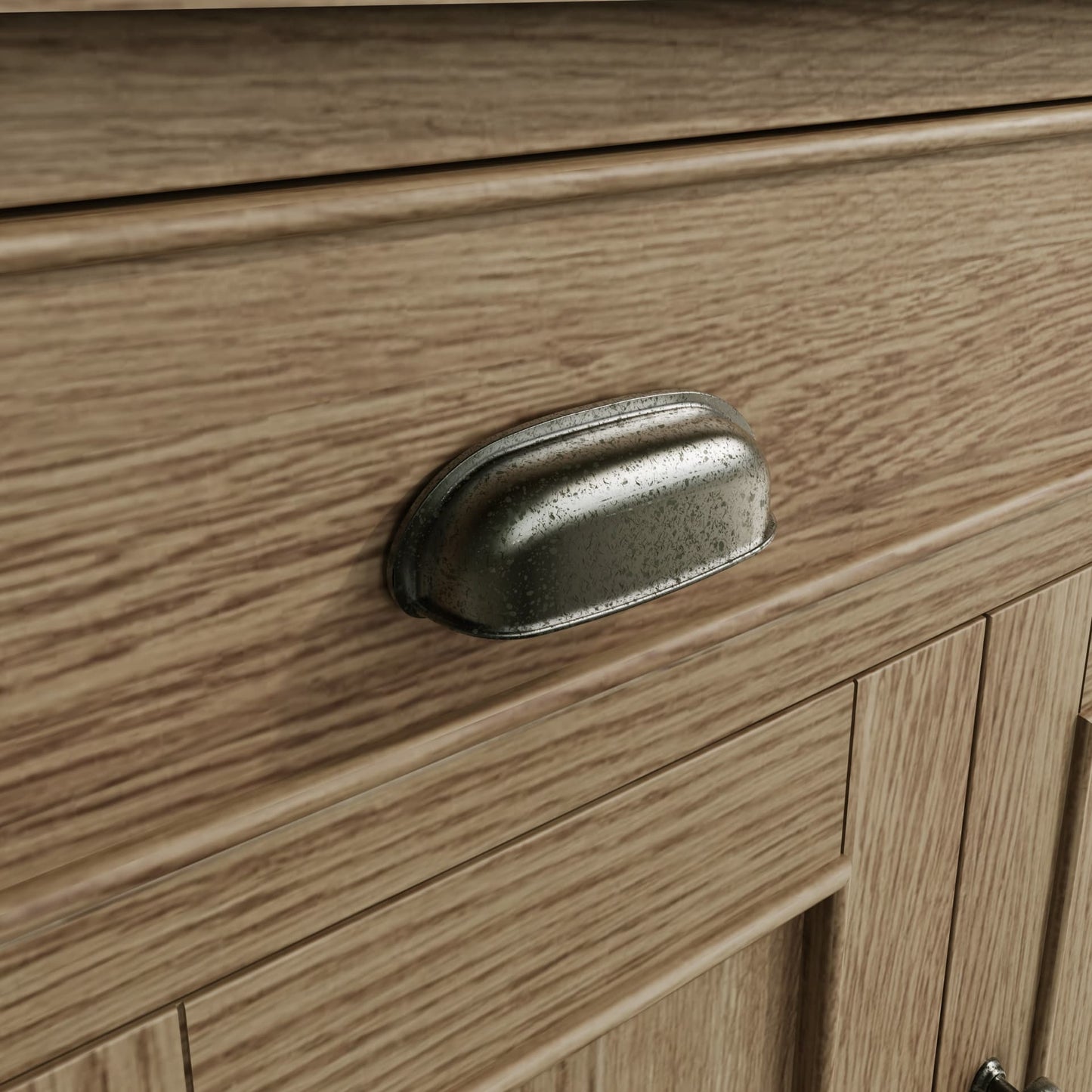 Close view on small sideboard drawer handle in antique finish