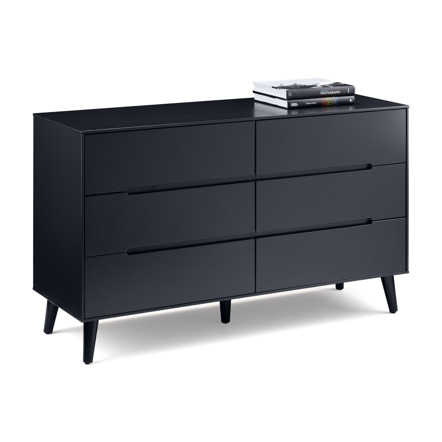Wide black 6 drawer chest with tapered legs is shown on white background with some books on top helping to size the piece