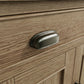 Close view on small sideboard drawer handle in antique finish 