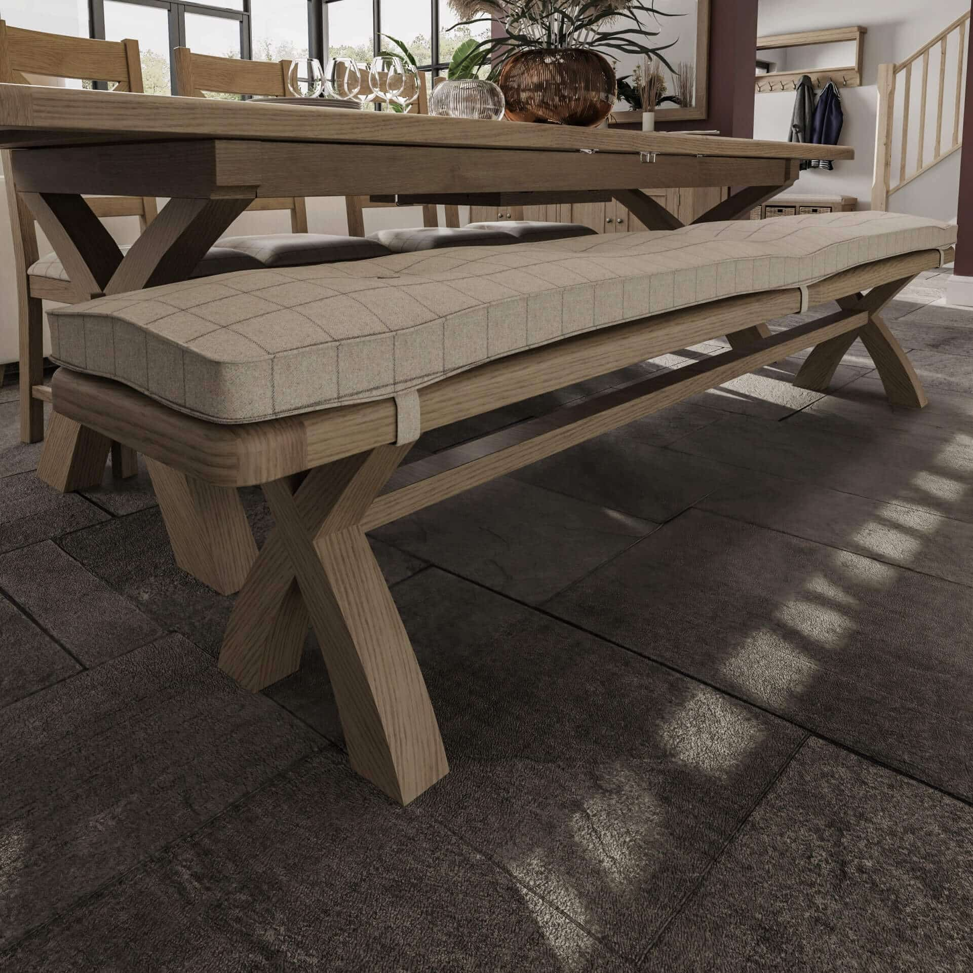 Trestle oak 2.5m dining bench with cushion on top shown in dining room setting next to trestle dining table