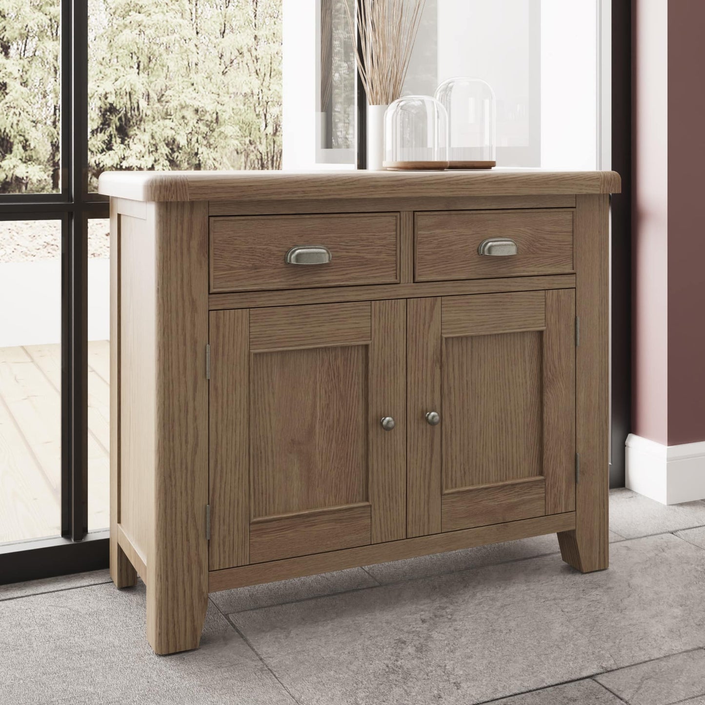 2 drawers 2 door oak sideboard shown in a room setting with decor on top