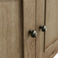 Close view on door decor and round handles in antique finish of the sideboard