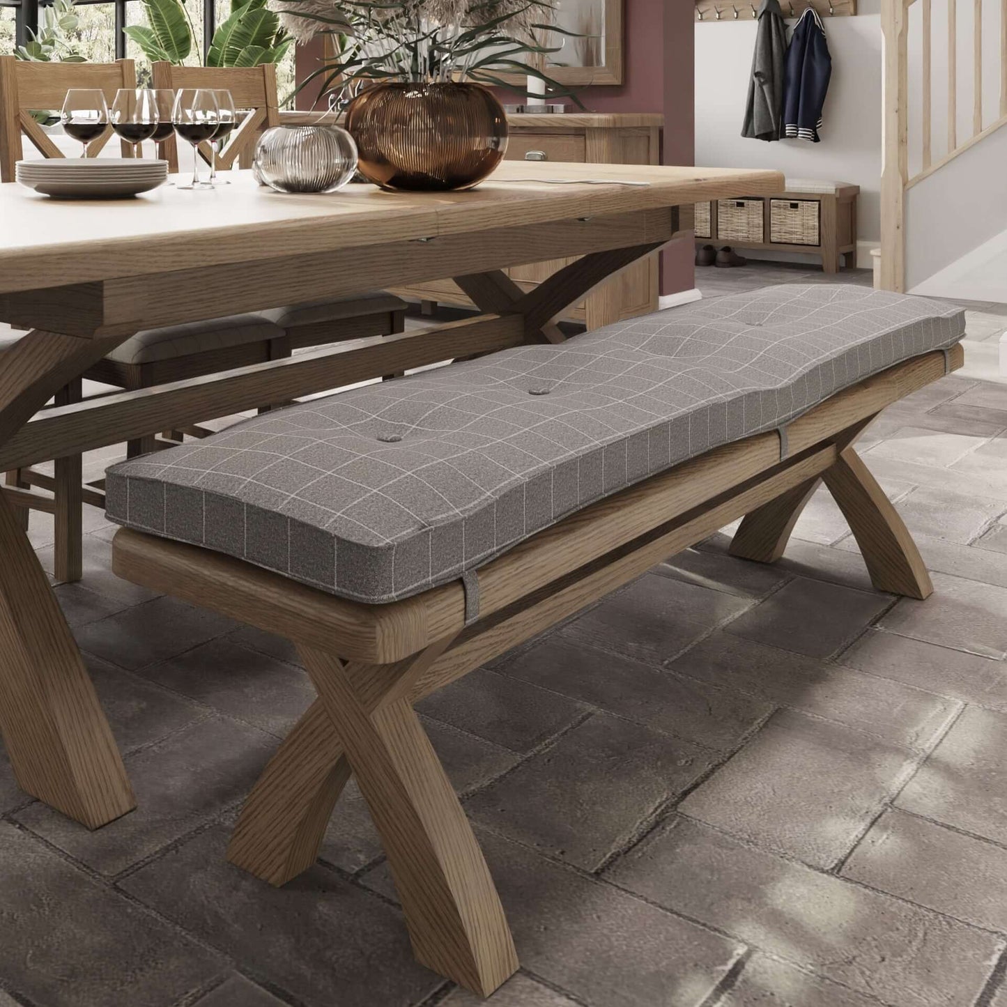 Grey check wool tufted bench cushion fitted to oak dining bench shown in room setting