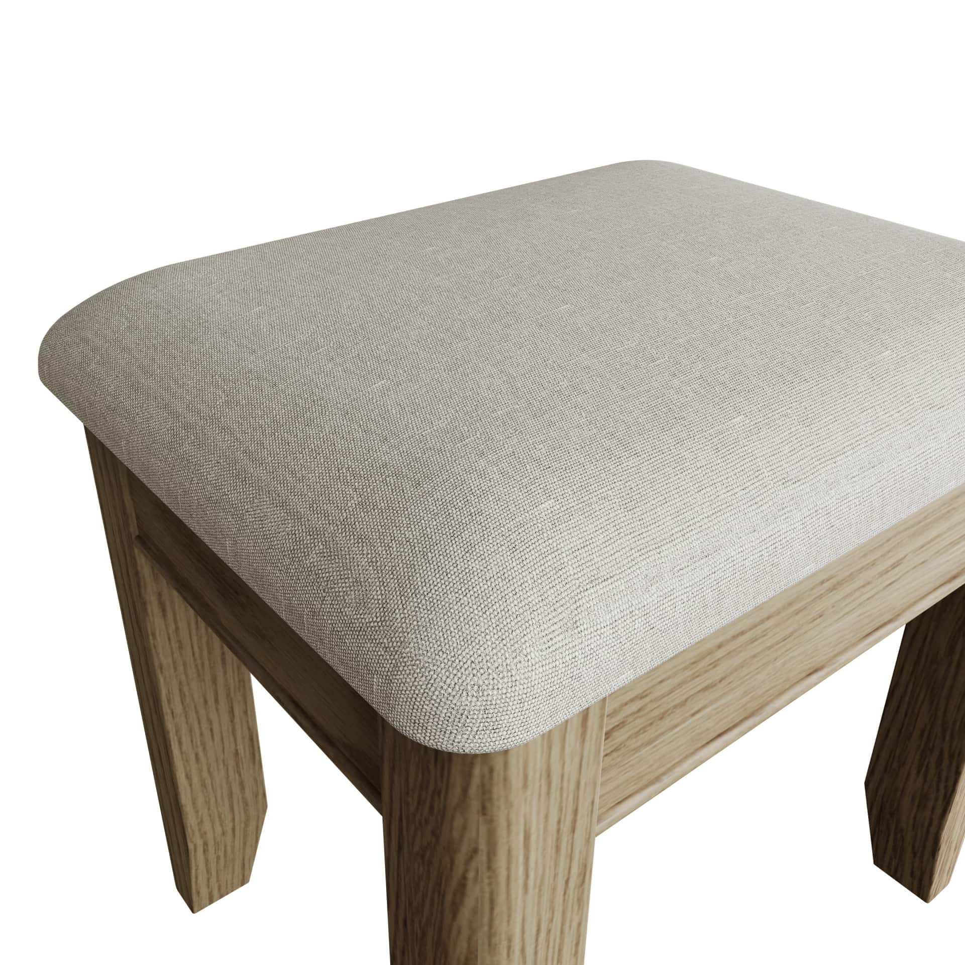 Close look at padded seat of the dressing table stool and rounded corners and edges of the wooden structure