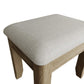 Close look at padded seat of the dressing table stool and rounded corners and edges of the wooden structure