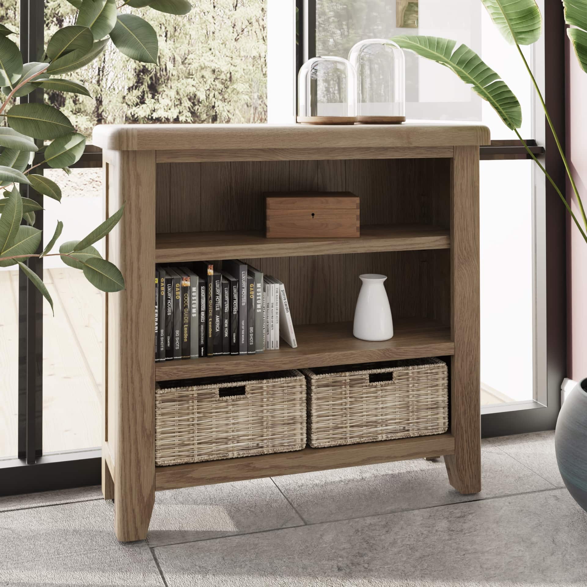 Small oak bookcase with wicker baskets is shown in a room setting with books and decor