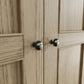 Close view on knob handles of the 2 door wardrobe with antique effect