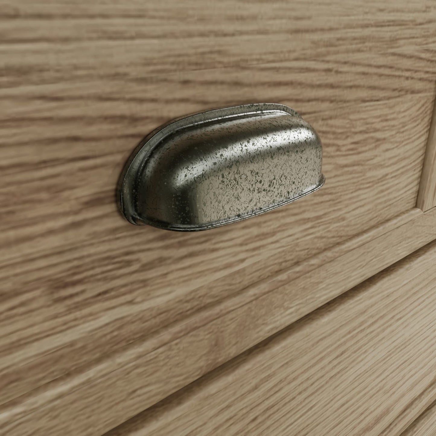 Close view on cup handles with antique effect of the drawers of the oak dresser