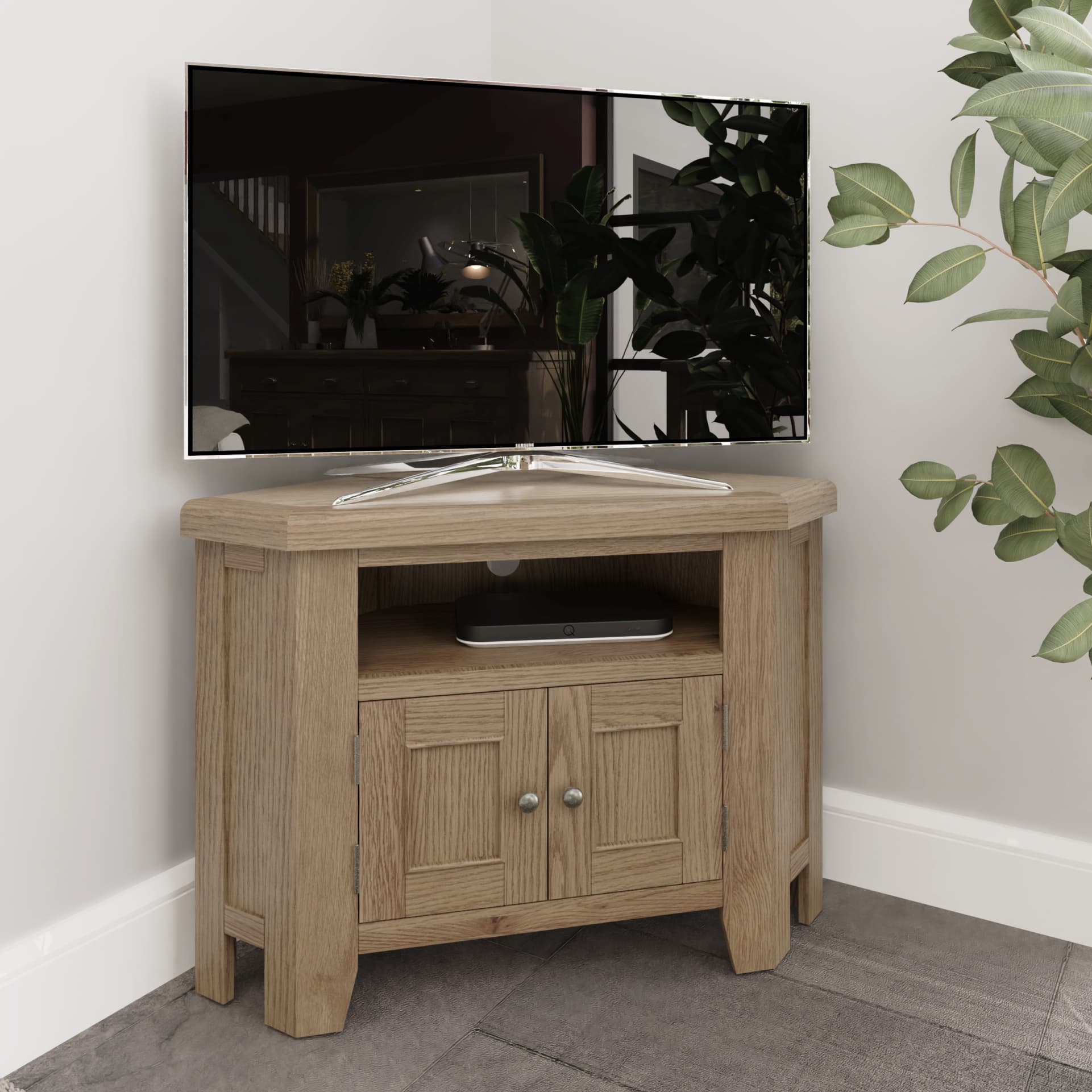 Oak corner TV stand is shown in a room setting with TV and media box