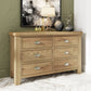 Oak wide 6 drawer chest is shown in a room setting with decor on top