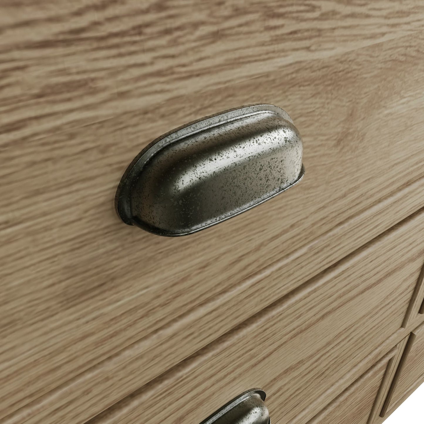 Close view on cup handles with antique effect of the drawers of the wide oak dresser