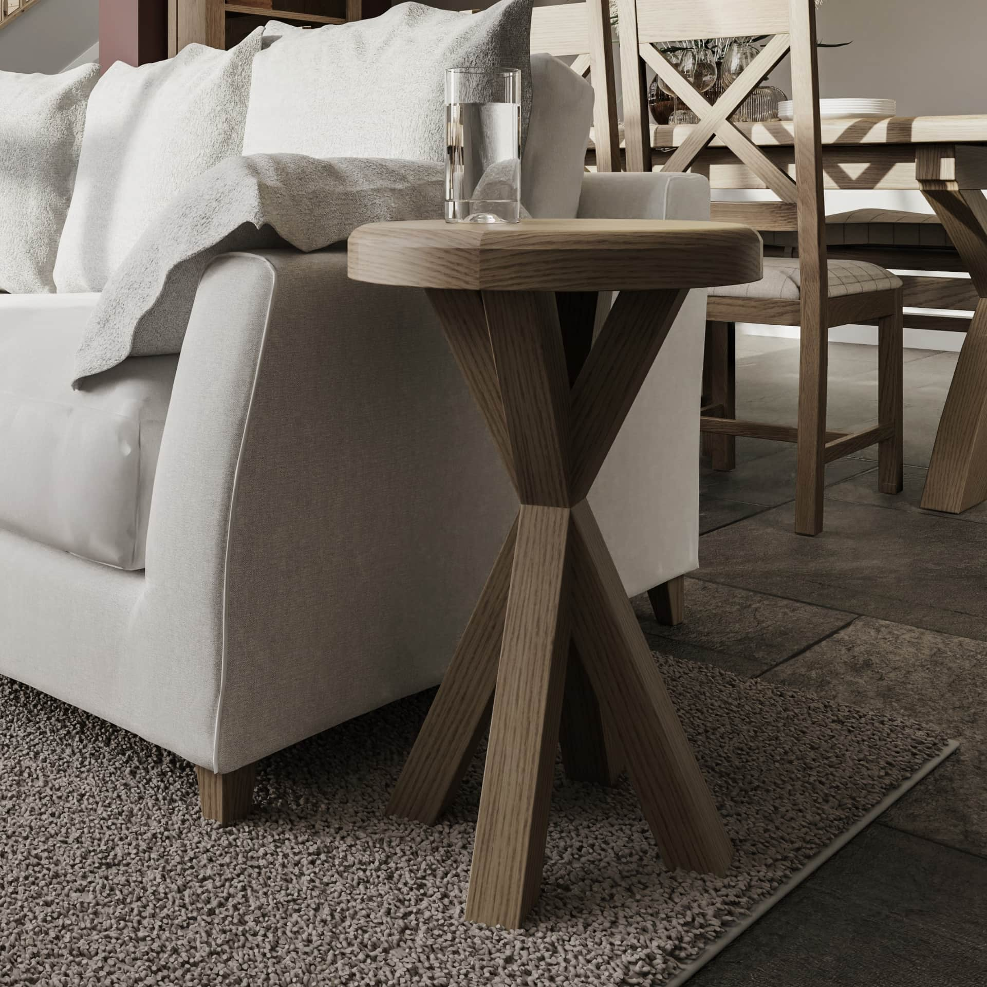 Round Oak Side Table is shown in room setting next to a sofa with a glass of water on top