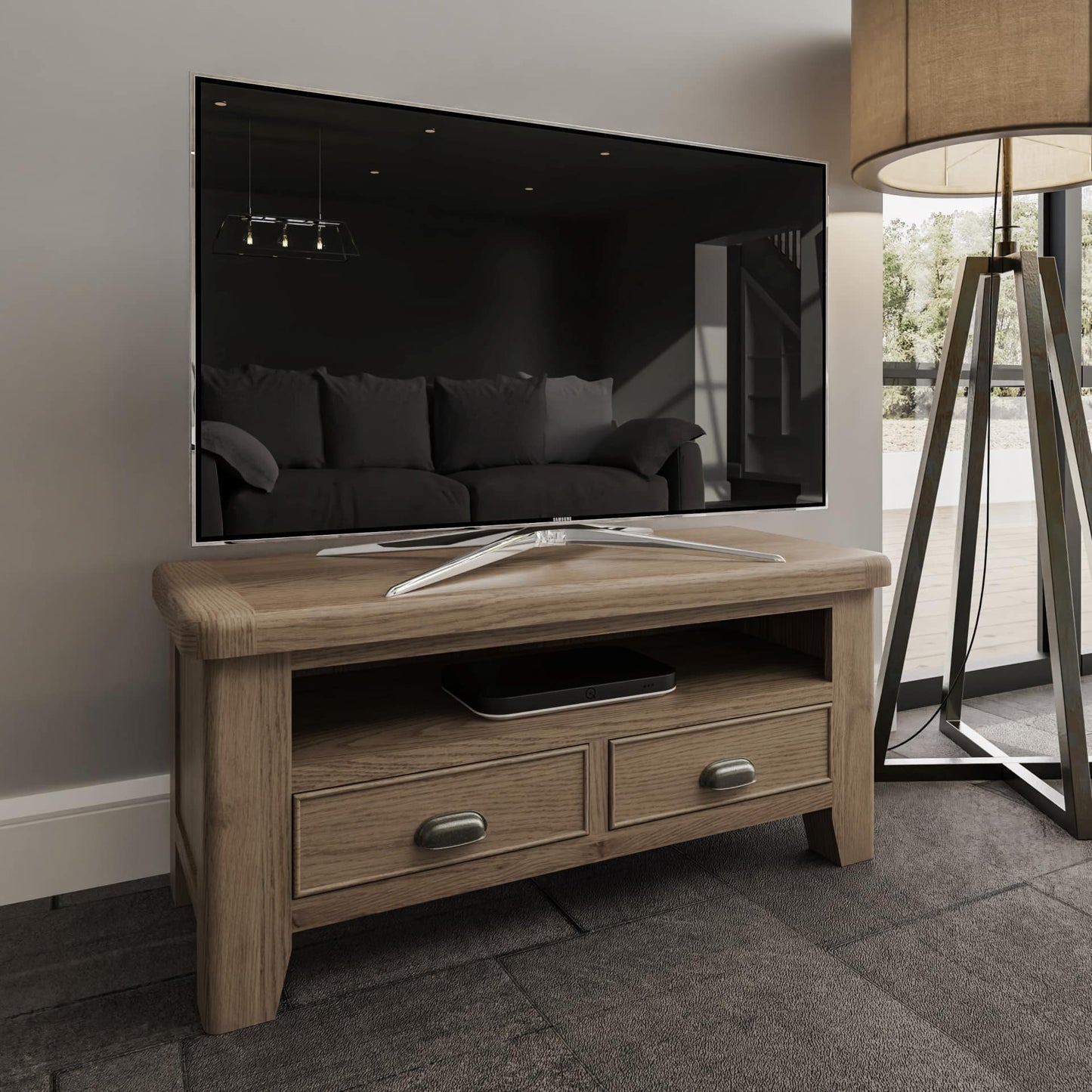 Small oak TV stand with a shelf and 2 drawer storage shown in a room setting with TV and media box in place