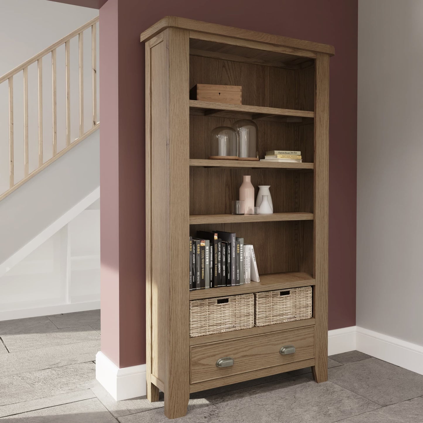 Large oak bookcase with drawer and wicker baskets is shown in a room setting with books and decor 