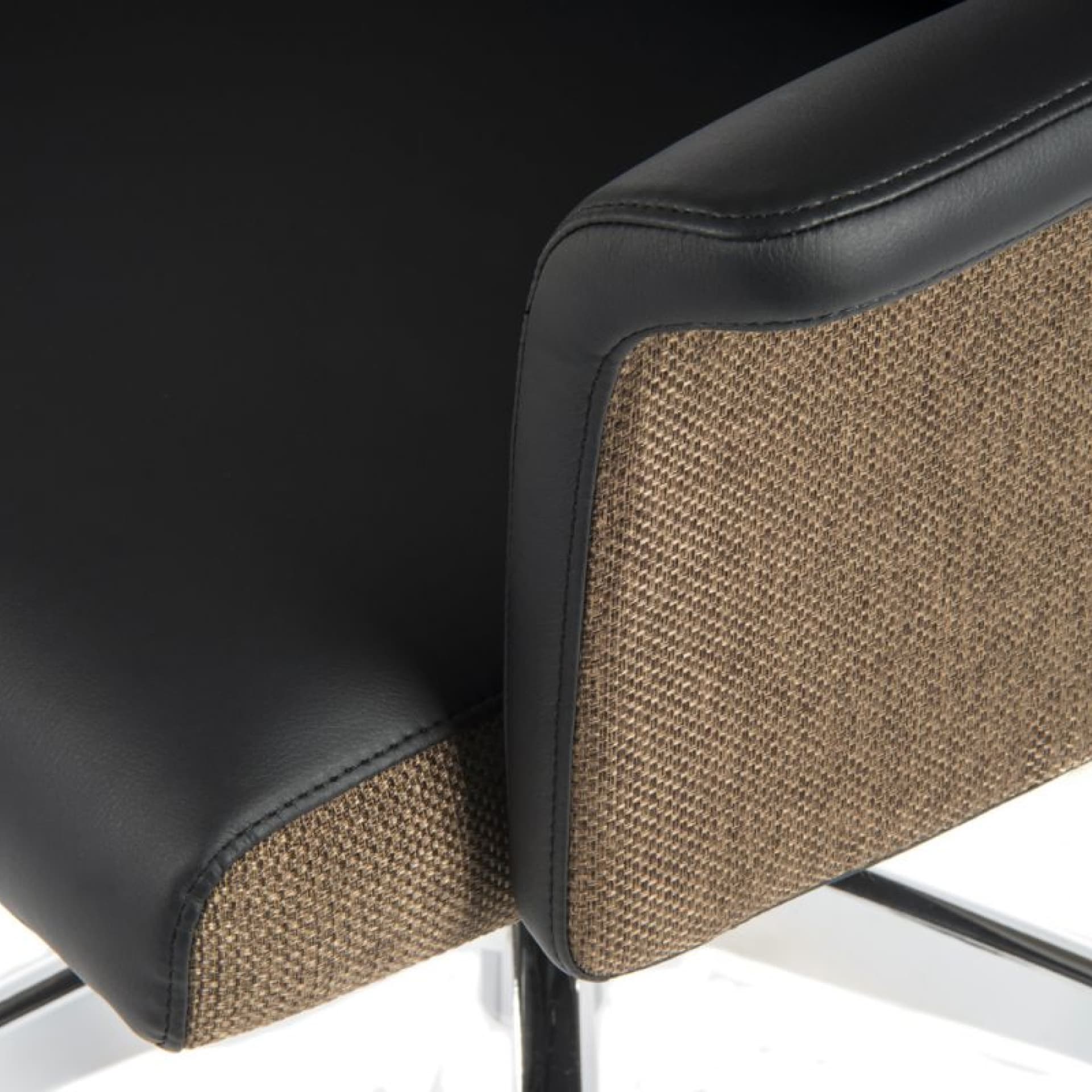 close look on two finishes of the office chair - black leather and chocolate woven fabric 