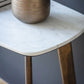 Close view on white marble top with beautiful grey veins and the edges of the table top