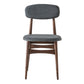 Minimalist elegant dining chair with tapered wooden legs and padded seat and backrest. Product only picture. Front view