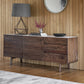 Side view on the wooden and marble top sideboard with 2 cupboards and marble top storage in the room setting with decor