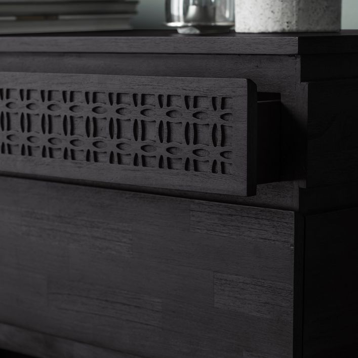 Close-up look at slightly open top drawer with frieze of blind fretwork.