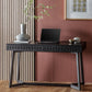 2 Drawer black wooden desk with blind fret decor of the drawers and geometric structure in a room setting with decor