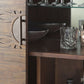 Zoomed view on the solid mango wood and glass shelves of the cabinet and door handles. Cabinet used as cocktail cabinet on the picture.