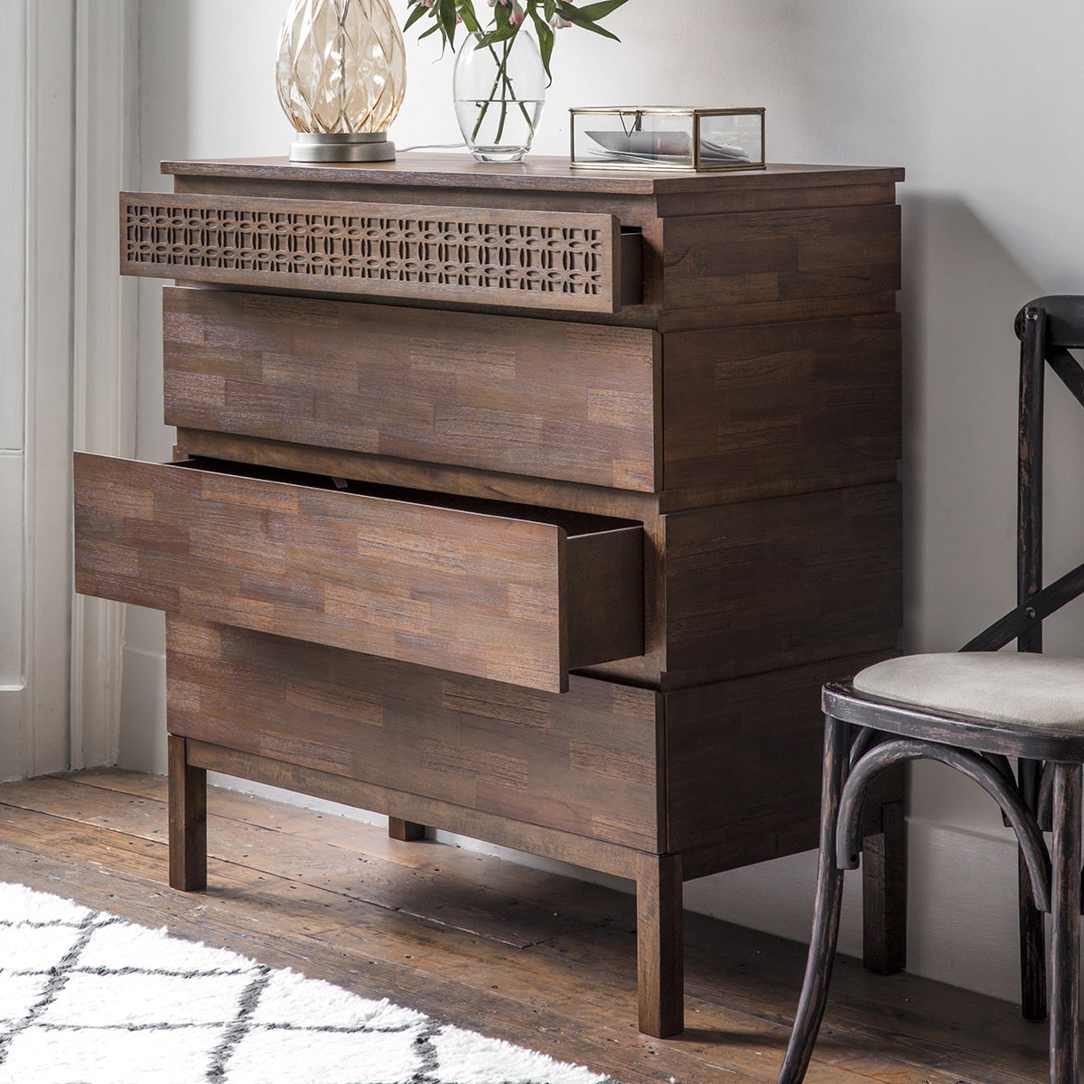 4 drawer chest in brown pictured showcasing storage with 2 drawers partly open in a room setting with decor.