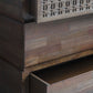 Closer look at partially open drawers, surfaces and edges of the 4 drawer brown wooden chest.