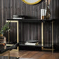 Oronero black and gold console table with metal legs and wood and glass top in the room setting