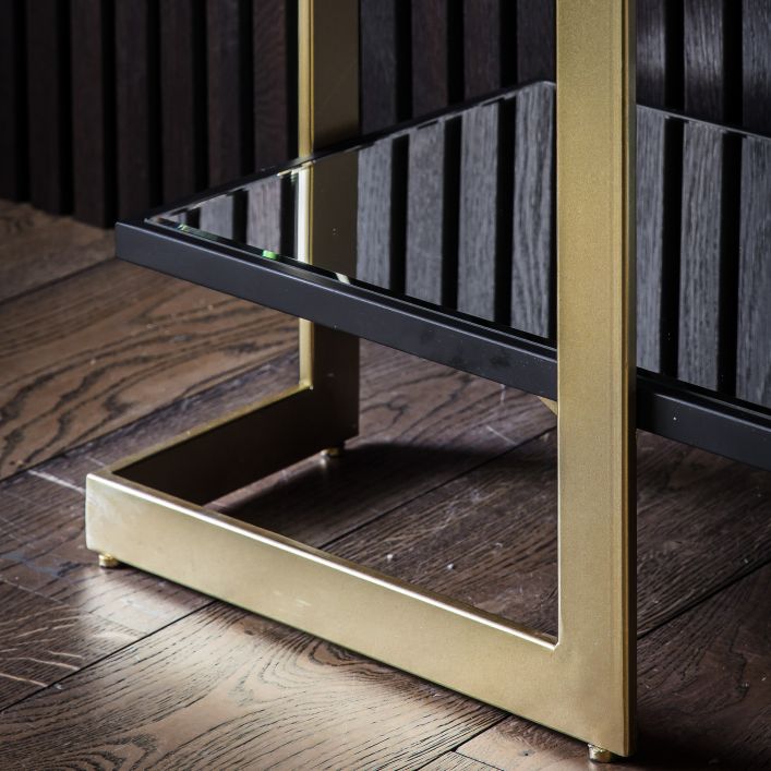 Zoomed in view on shelving and legs of the black and gold console table