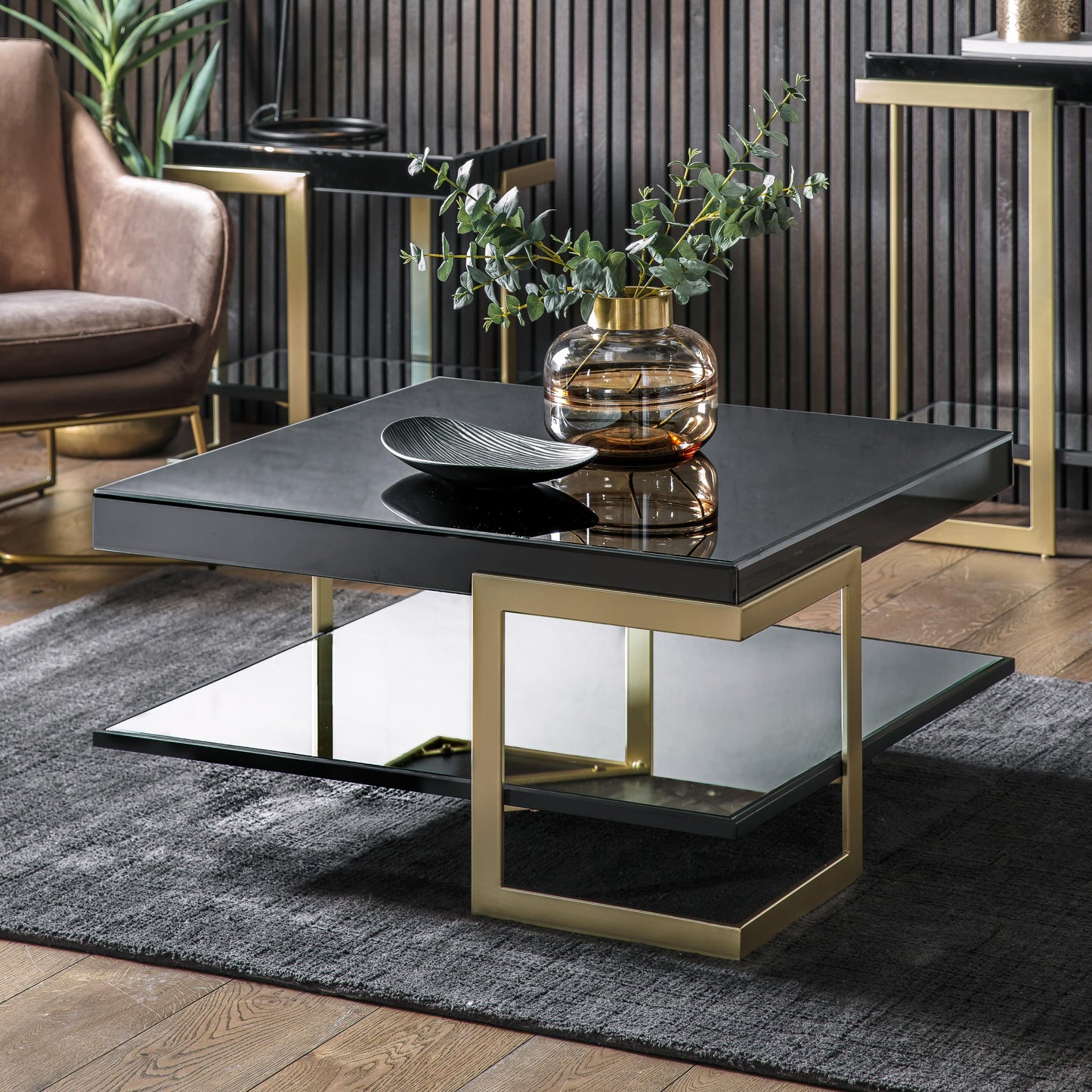 Black and gold contemporary square coffee table in lounge setting